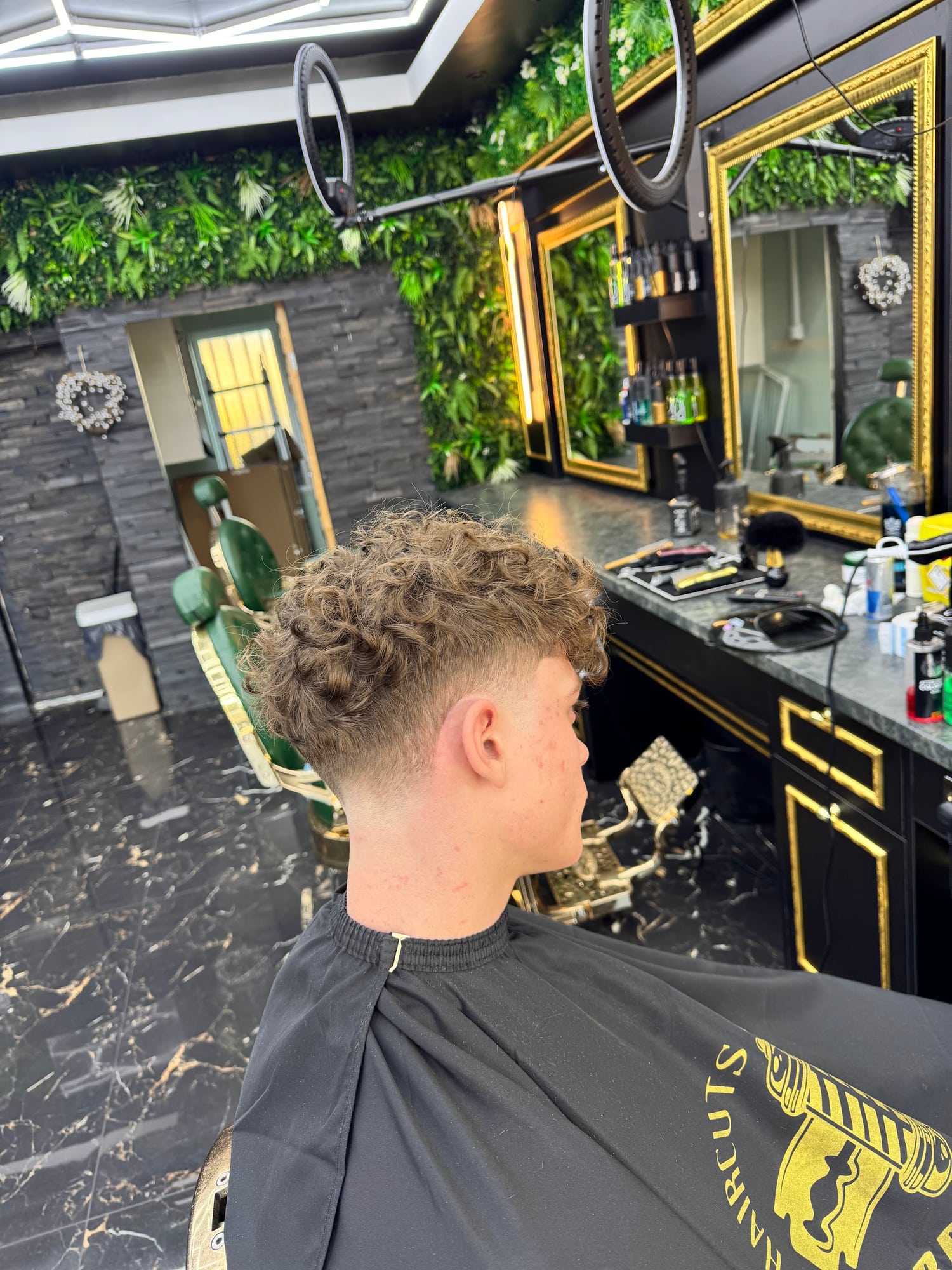 Textured haircut with a close fade, finished at Hardy Barbers