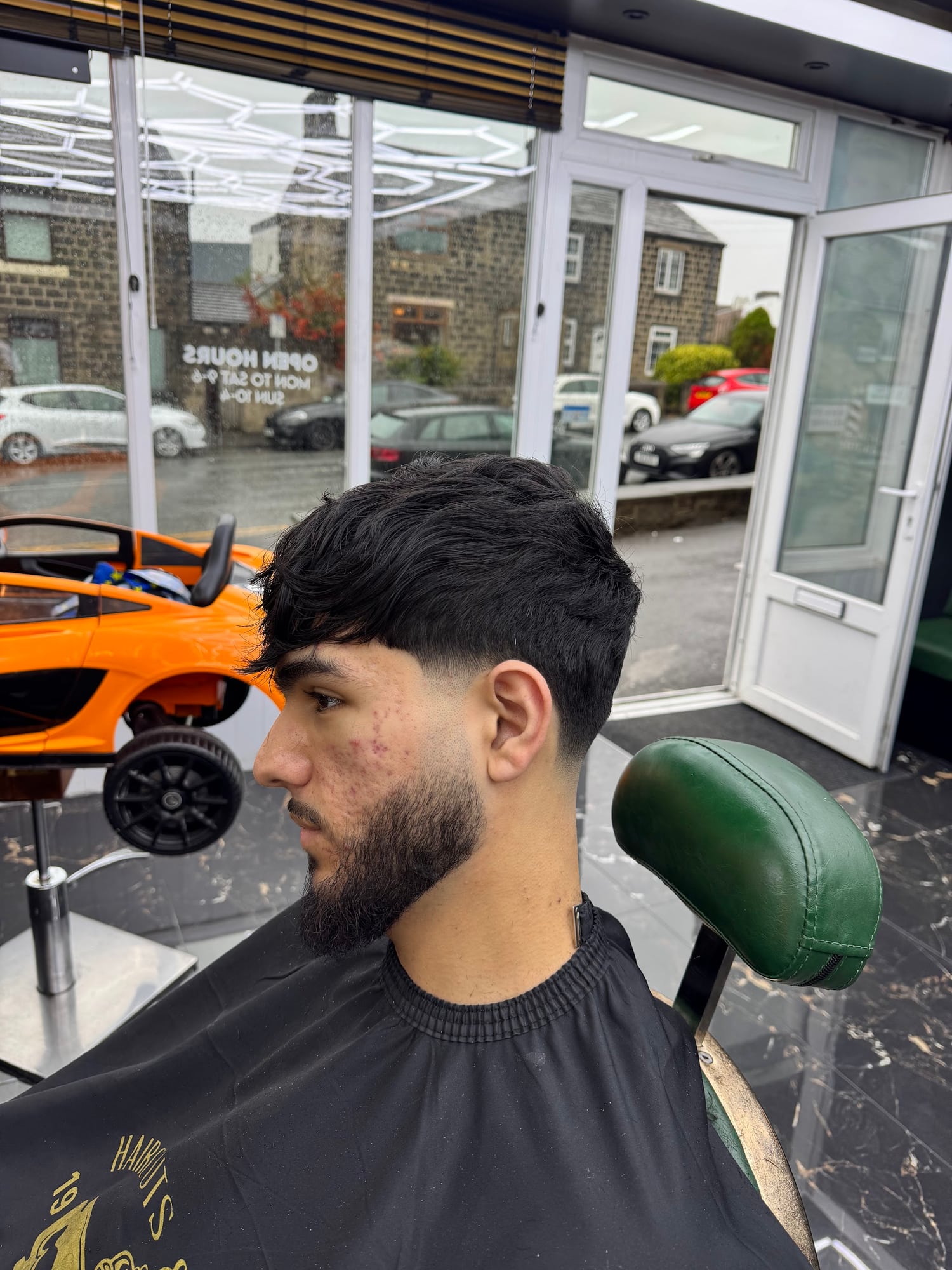 Finished dark textured haircut by the Hardy Barbers entrance